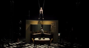 Movie still from “The Savages” (2007), directed by Tamara Jenkins – A man and a woman are hanging from a rope in a dark room; Wide shot, Low angle