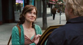 Movie still from “The Savages” (2007), directed by Tamara Jenkins – A woman standing next to a tree on the sidewalk; Close Up shot, Over the shoulder angle