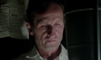 Movie still from “The Scar” (1976), directed by Krzysztof Kieslowski – A person wearing a white shirt; Close Up shot, Low angle