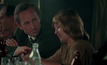 Movie still from “The Scar” (1976), directed by Krzysztof Kieslowski – A man and a woman sitting at a dinner table; Close Up shot, Over the shoulder angle
