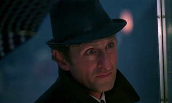 Movie still from “The Scar” (1976), directed by Krzysztof Kieslowski – A person wearing a hat; Close Up shot, Low angle