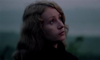 Movie still from “The Scar” (1976), directed by Krzysztof Kieslowski – A person with long blonde hair; Close Up shot, Low angle