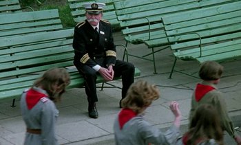 Movie still from “The Scar” (1976), directed by Krzysztof Kieslowski – An old man sitting on top of a wooden bench; Wide shot, Over the shoulder angle