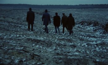 Movie still from “The Scar” (1976), directed by Krzysztof Kieslowski – A group of people walking across a snow covered field; Wide shot, High angle