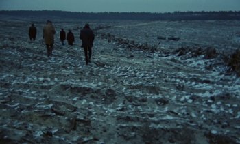 Movie still from “The Scar” (1976), directed by Krzysztof Kieslowski – A group of people walking across a snow covered field; Extreme Wide shot, High angle