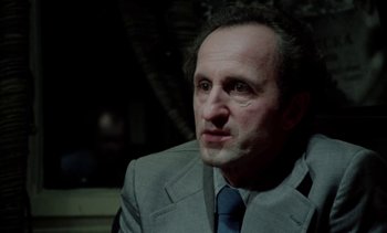 Movie still from “The Scar” (1976), directed by Krzysztof Kieslowski – A person wearing a suit and tie; Close Up shot, Low angle