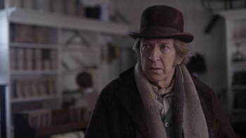 Movie still from “Anne with an E” (2017), created by Moira Walley-Beckett – An older man wearing a brown hat and a brown coat; Close Up shot, Over the shoulder angle