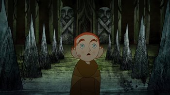 Movie still from “The Secret of Kells” (2009), directed by Nora Twomey – A cartoon of a boy in a cave with trees in the background; Medium shot, High angle