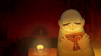 Movie still from “The Secret of Kells” (2009), directed by Nora Twomey – An old man holding a book in front of a candle in a dark room; Close Up shot, Low angle
