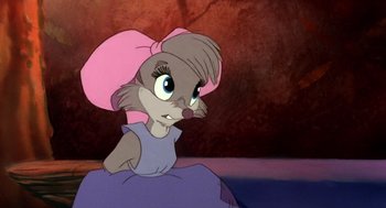 Movie still from “The Secret of NIMH” (1982), directed by Don Bluth – A mouse with a pink bow in her hair; Close Up shot, Over the shoulder angle