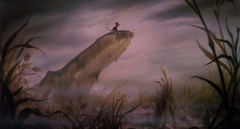 Movie still from “The Secret of NIMH” (1982), directed by Don Bluth – A painting of a monkey sitting on top of a cliff; Wide shot, Low angle