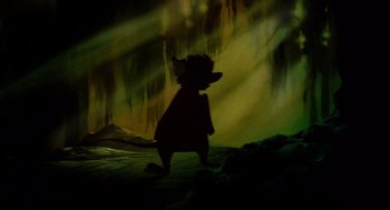 Movie still from “The Secret of NIMH” (1982), directed by Don Bluth – A silhouette of a bear in a dark forest; Wide shot, Low angle