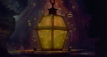 Movie still from “The Secret of NIMH” (1982), directed by Don Bluth – An oil lamp is lit up with yellow lights; Wide shot, High angle