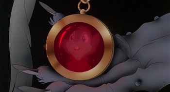 Movie still from “The Secret of NIMH” (1982), directed by Don Bluth – A red and yellow pendant; Extreme Close Up shot, High angle