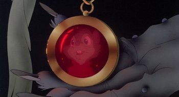 Movie still from “The Secret of NIMH” (1982), directed by Don Bluth – A red and gold necklace with an image of a squirrel in it; Extreme Close Up shot, High angle