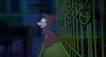 Movie still from “The Secret of NIMH” (1982), directed by Don Bluth – A mouse that is sitting on the ground; Wide shot, High angle