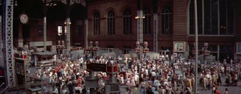 Movie still from “The Seven Year Itch” (1955), directed by Billy Wilder – A crowd of people gathered in front of a large building; Extreme Wide shot, High angle