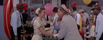 Movie still from “The Seven Year Itch” (1955), directed by Billy Wilder – An older woman and a young man are shaking hands; Medium shot, Over the shoulder angle