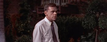 Movie still from “The Seven Year Itch” (1955), directed by Billy Wilder – A man in a white dress shirt and a tie; Medium shot, Low angle