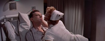 Movie still from “The Seven Year Itch” (1955), directed by Billy Wilder – A man and a woman in a hospital room; Medium shot, Low angle