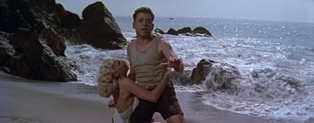 Movie still from “The Seven Year Itch” (1955), directed by Billy Wilder – A man and a woman on the beach; Medium shot, Low angle