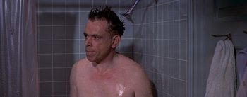 Movie still from “The Seven Year Itch” (1955), directed by Billy Wilder – A man taking a shower in a tiled bathroom; Close Up shot, Over the shoulder angle