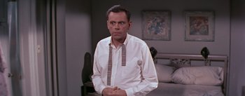 Movie still from “The Seven Year Itch” (1955), directed by Billy Wilder – An older man in a white shirt and a tie; Medium shot, Over the shoulder angle