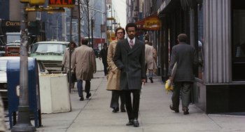 Movie still from “The Seven-Ups” (1973), directed by Philip D'Antoni – A group of people walking down a sidewalk; Wide shot, Low angle