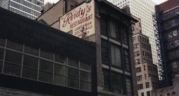 Movie still from “The Seven-Ups” (1973), directed by Philip D'Antoni – A restaurant sign on the side of a building; Extreme Wide shot, Overhead angle