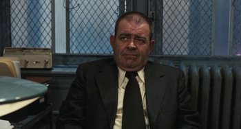 Movie still from “The Seven-Ups” (1973), directed by Philip D'Antoni – A person wearing a suit and tie; Close Up shot, Low angle