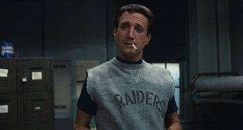 Movie still from “The Seven-Ups” (1973), directed by Philip D'Antoni – A person smoking a cigarette in a room; Close Up shot, Low angle