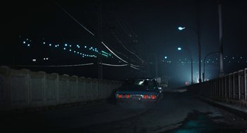 Movie still from “The Seven-Ups” (1973), directed by Philip D'Antoni – A car driving down a street at night; Extreme Wide shot, High angle