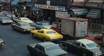 Movie still from “The Seven-Ups” (1973), directed by Philip D'Antoni – A busy city street filled with cars and pedestrians; Extreme Wide shot, High angle