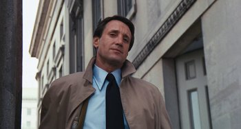 Movie still from “The Seven-Ups” (1973), directed by Philip D'Antoni – A person wearing a jacket and tie; Close Up shot, Low angle