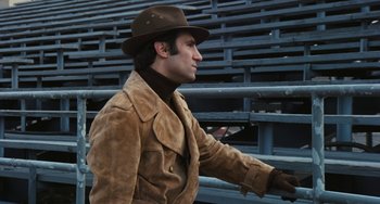 Movie still from “The Seven-Ups” (1973), directed by Philip D'Antoni – A man wearing a brown jacket and a brown hat; Medium shot, High angle