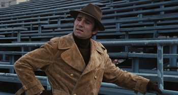 Movie still from “The Seven-Ups” (1973), directed by Philip D'Antoni – A man in a brown jacket and a brown hat; Medium shot, High angle