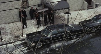 Movie still from “The Seven-Ups” (1973), directed by Philip D'Antoni – A black car parked on the side of the street; Wide shot, High angle