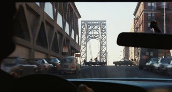 Movie still from “The Seven-Ups” (1973), directed by Philip D'Antoni – A view from a car of a bridge with cars driving on it; Extreme Wide shot, Over the shoulder angle