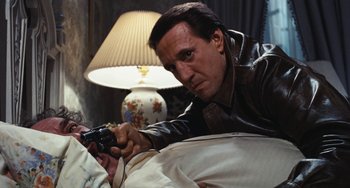 Movie still from “The Seven-Ups” (1973), directed by Philip D'Antoni – A man holding a video game controller in his hand; Close Up shot, High angle