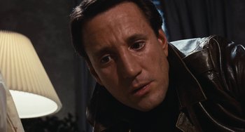 Movie still from “The Seven-Ups” (1973), directed by Philip D'Antoni – A person wearing a leather jacket; Close Up shot, Low angle
