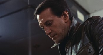 Movie still from “The Seven-Ups” (1973), directed by Philip D'Antoni – A person wearing a leather jacket; Close Up shot, Low angle