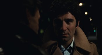 Movie still from “The Seven-Ups” (1973), directed by Philip D'Antoni – A person wearing a coat; Close Up shot, Over the shoulder angle