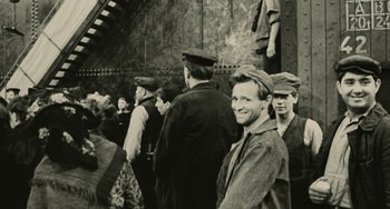 Movie still from “The Ship Sails On” (1983), directed by Federico Fellini – A group of men standing next to each other; Medium shot, High angle