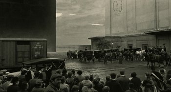 Movie still from “The Ship Sails On” (1983), directed by Federico Fellini – An old photo of a crowd of people and horses; Extreme Wide shot, High angle