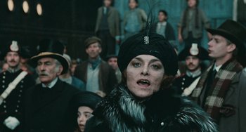 Movie still from “The Ship Sails On” (1983), directed by Federico Fellini – A woman in a fur coat and a black hat; Close Up shot, Over the shoulder angle