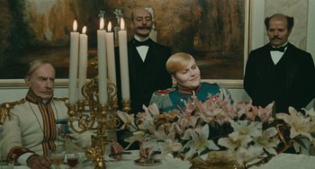 Movie still from “The Ship Sails On” (1983), directed by Federico Fellini – A man and a woman sitting in front of candles; Medium shot, Over the shoulder angle