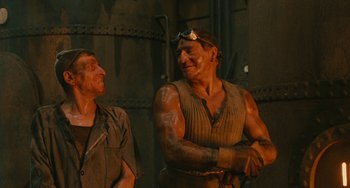 Movie still from “The Ship Sails On” (1983), directed by Federico Fellini – Two men are standing next to each other; Medium shot, Low angle