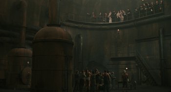 Movie still from “The Ship Sails On” (1983), directed by Federico Fellini – A group of people standing in a large room; Extreme Wide shot, High angle