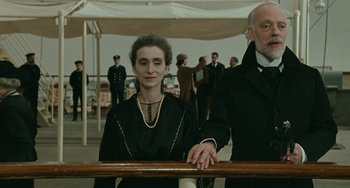 Movie still from “The Ship Sails On” (1983), directed by Federico Fellini – A man and a woman standing next to a railing; Medium shot, Low angle