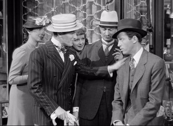 Movie still from “The Shop Around the Corner” (1940), directed by Ernst Lubitsch – A group of people standing next to each other wearing hats; Medium shot, Over the shoulder angle